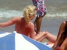 Topless teens showing young firm boobs and puffy nipples on the beach!
